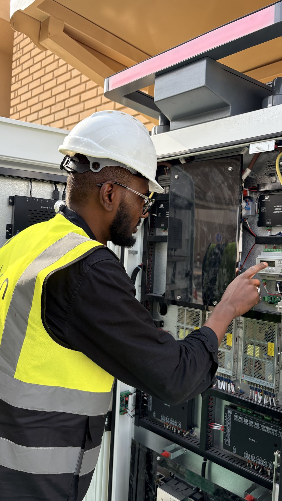 An Auton engineer commissioning the public DC fast charger