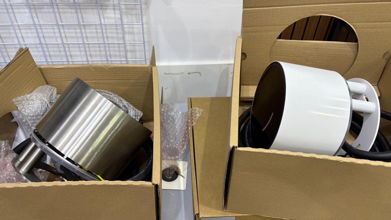 Two Voltie units, stainless steel and white, unboxed during testing